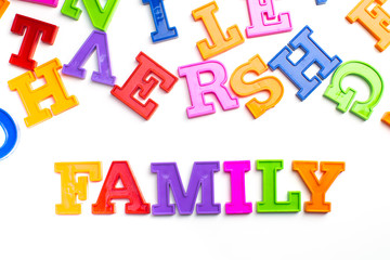 Heap of plastic colored alphabet letters close up. Family