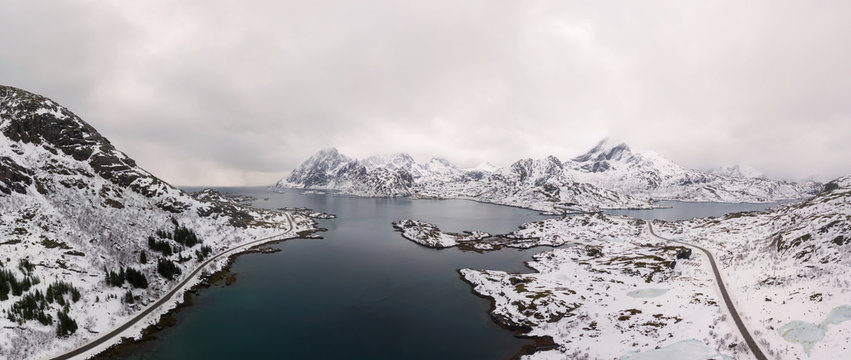 Aerial drone panoramic view of amazing Lofoten Islands winter scenery with famous Reine fishing village Norway, Scandinavia. Top view picture at sunset.