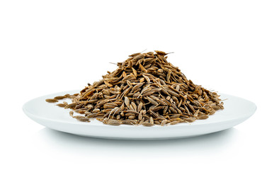 caraway seeds in white plate on white background