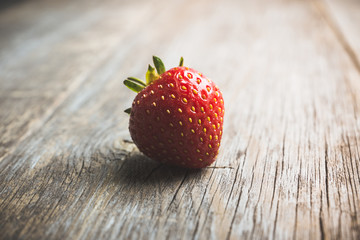 Ripe and juicy strawberries on the dark rustic background. Selective focus. Shallow depth of field. 