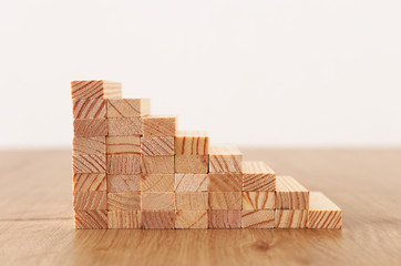 Business image of arranging wood blocks stacking as step stairs. Success and development concept