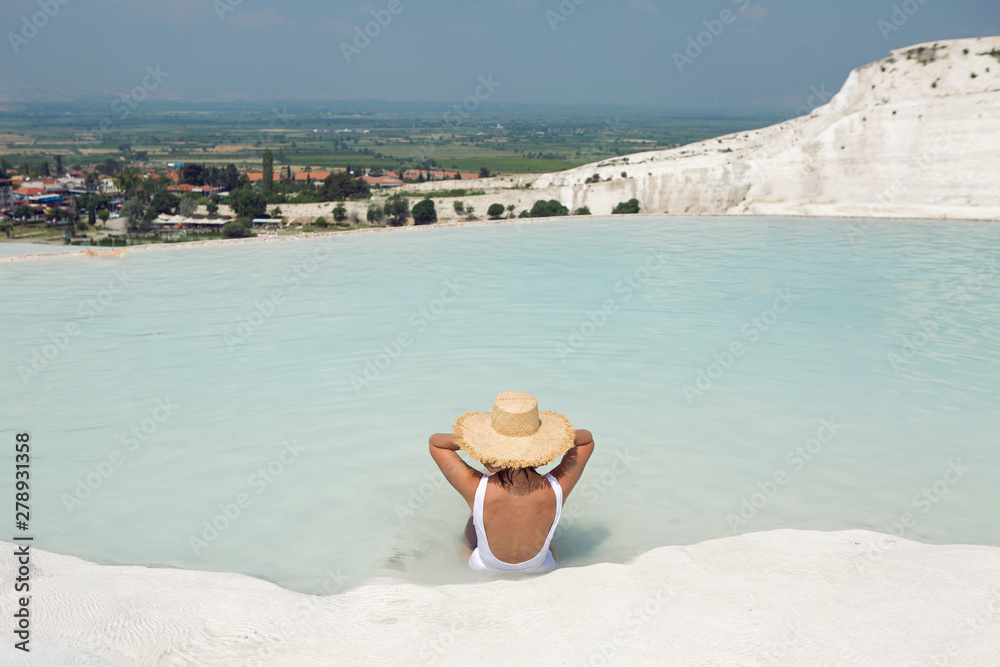 Wall mural sexy young woman lie in a swimsuit at the white limestone mountain