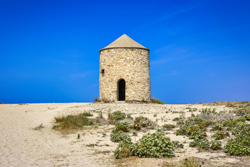 Fototapeta na wymiar Old windmill on Gyra beach