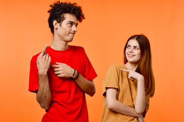 Obraz premium Young couple in multi-colored t-shirts