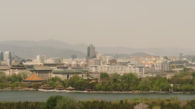Beijing cityscape, pan across lake Qianhai and the city.