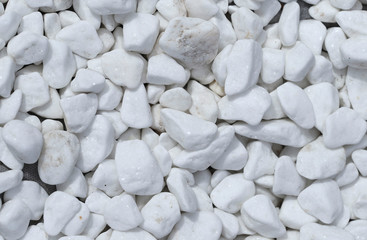 Background texture of white stone of different shapes. View from above, close-up, horizontal. Concept of design and gardening.