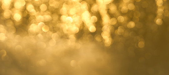 Golden bokeh background close up. Abstract blurred glowing background.