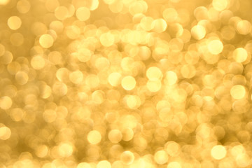 Golden yellow background with abstract blurred highlights. Bokeh in blur.