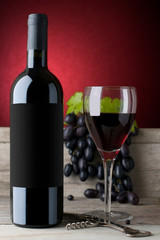  bottle of red wine with grapes and black label