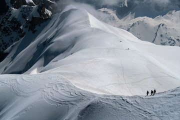 Mountaineers descending down to a glacier from Aiguille Du Midi in Chamonix, France