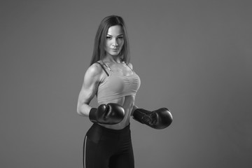 young slim muscular girl in boxing gloves