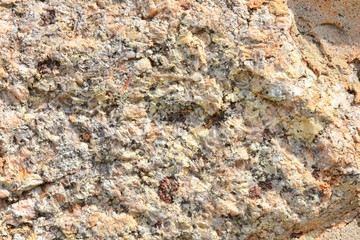 Natural stone background with textured surface. Pattern rocks with rough structure. Aging colorful mountain backdrop. Natural stone surface with empty space for image or text. Aging granite texture
