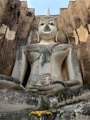 huge 11 m wide and 15 m high seated Buddha in Wat Si Chum  in famous Sukhothai Historical Park, a UNESCO World Heritage Site, the ancient 13th and 14th centuries capital of Sukhothai. Thailand