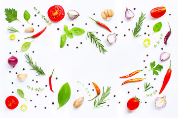 Various fresh vegetables and herbs on white background.