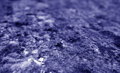 Old stone surface with blur effect in blue tone.