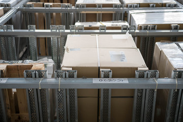 Warehouse interior with racks and boxes. Interior shot of a warehouse with high racks and boxes inventory