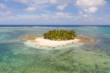 Guyam island, Siargao, Philippines. Small island with palm trees and a white sandy beach. Philippine Islands.