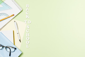 School accessories on light green background