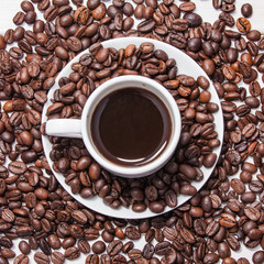 Coffee in a white cup and grains