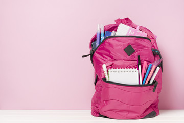 Pink backpack with school materials