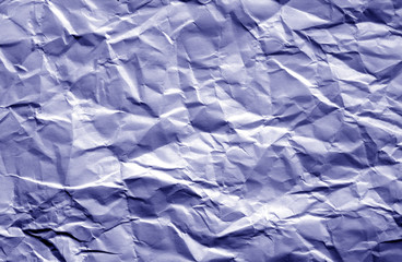 Crumpled sheet of paper with blur effect in blue color.