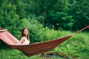 young woman reading a book in the park