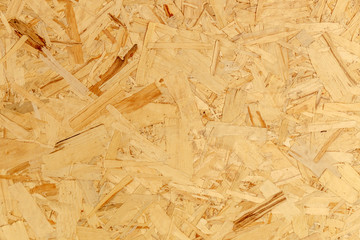 Fototapeta na wymiar close up pressed wooden panel background texture of oriented strand board - OSB wood