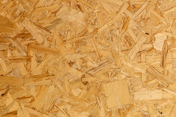 close up pressed wooden panel background texture of oriented strand board - OSB wood
