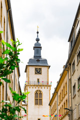 small street with apartments and tower, belfry, of Thionville, France