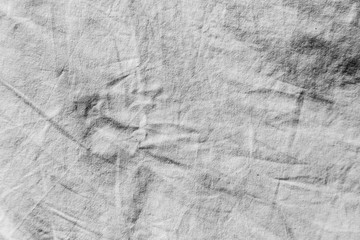 Naklejka premium Dirty white fabric background in direct sunlight with clear, deep shadows.