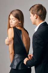 Man zipping up girlfriend's dress. man helping woman zip up dress. Gentleman behavior, Care concept.