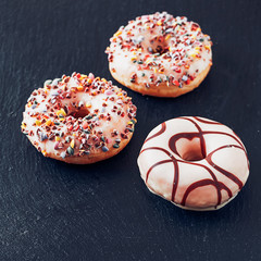 Sweet donuts on the slate serving plate
