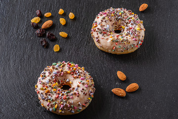 The donuts and nuts n thedark slate platter