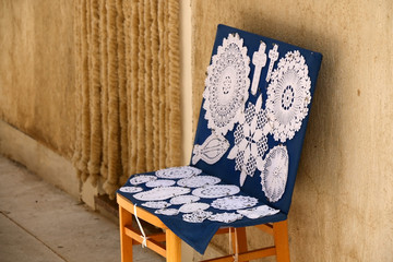 Traditional lace work on display on the narrow street of town Pag, island Pag, Croatia. Pag is famous for its traditional intricate lace.
