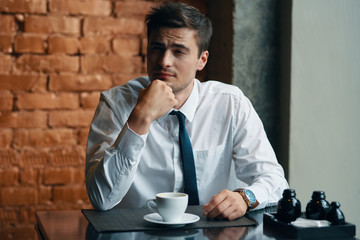 man drinking coffee in cafe