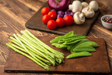 Fresh green vegetables on a wooden table. Background. Healthy lifestyle