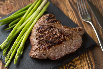 Meat table : grilled beef fillet with asparagus on wooden table