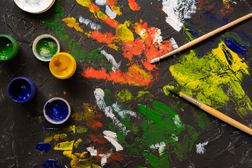 gouache paints with brushes, concrete surface decoration
