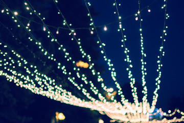 night time city bokeh lights background of garland, out of focus blur.
