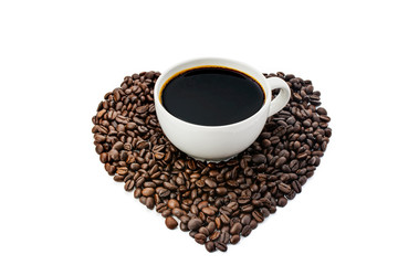 Black coffee in a white coffee cup and a heart-shaped coffee bean on a white background