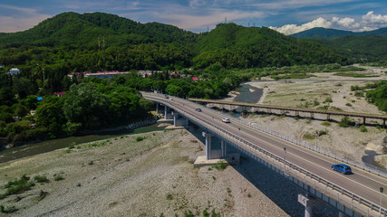 Aerial view of traffic on bridge, 2 lane road with cars