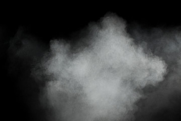 White powder explosion on black background. Abstract white dust texture fly on the air.
