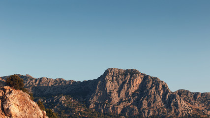 Beautiful landscape in the mountain view. Beautiful view of the Taurus mountains in the morning sun against the blue sky. Kemer, Turkey.