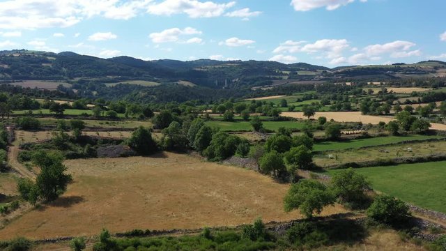 Mixed woodland and pasture bocage aerial shot sunny day agricultural landscape France