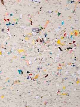 Bulletin board at UMass with staples and small pieces of paper