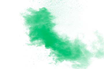 Freeze motion of green dust explosion on white background. Throwing green powder out of hand against  background.