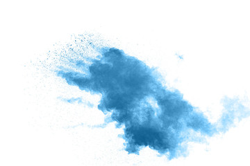 Freeze motion of blue dust explosion on white background. Throwing blue powder out of hand against dark background.