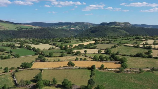 Marvejols bocage fields and hedges mixed wood and pasture. Aerial shot mountains in background Aveyron France