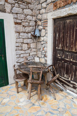 Table and wooden chairs of an old cafe in a tourist town.