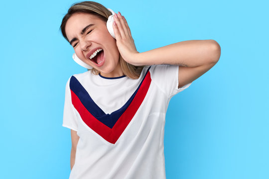 Young Woman Listening To Music Singing Along